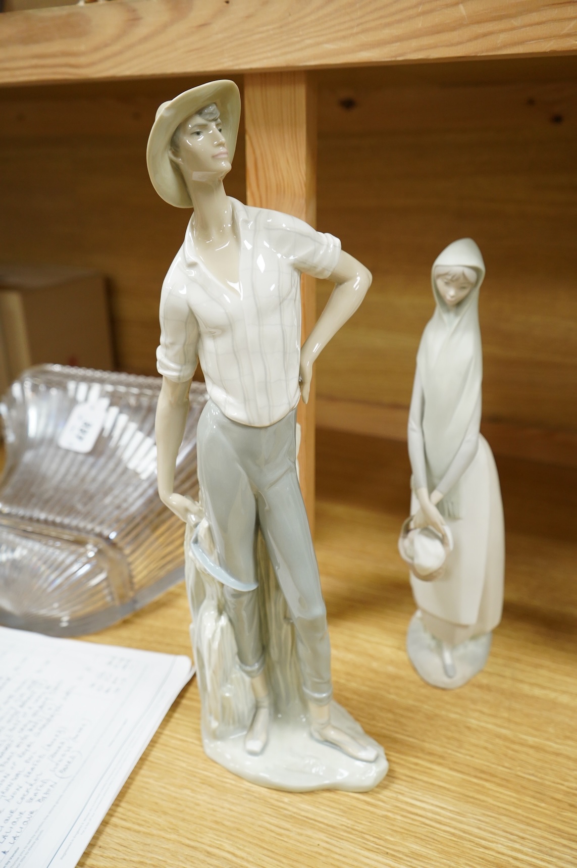 A group of Lladro figures: Bust of a lady in a lace veil, Girl with a basket, Lady holding gloves and a male reaper, 43cm high - 4 items, some boxed.